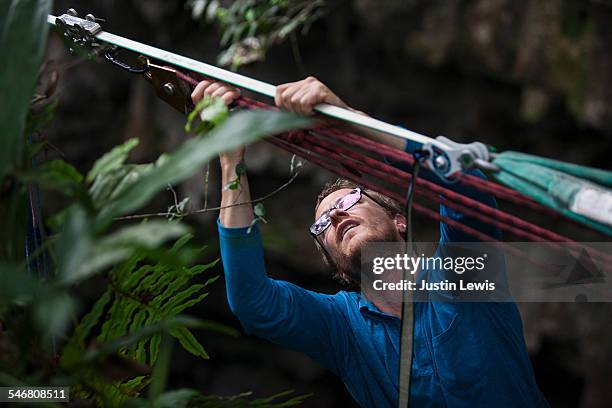 man checks climbing gear - wonderlust2015 stock pictures, royalty-free photos & images