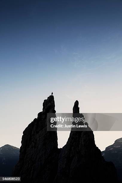 man silhouetted at the top of the pinnacle - wonderlust2015 stock pictures, royalty-free photos & images