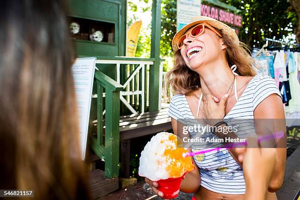 laughing woman eating shaved ice - shaved ice stockfoto's en -beelden