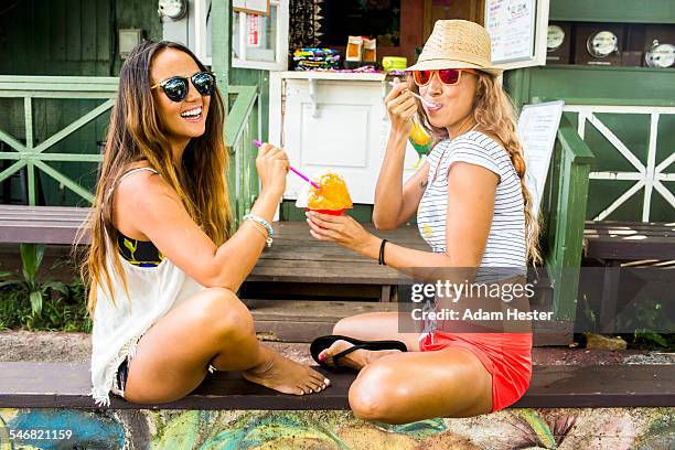 smiling women sharing shaved ice - shaved ice stockfoto's en -beelden