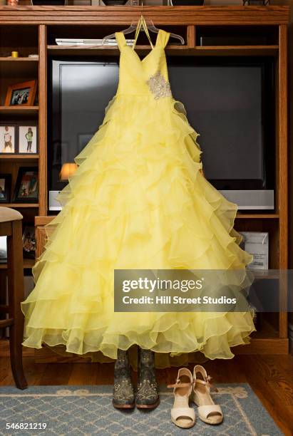 yellow quinceanera dress hanging in living room - prom dress stock pictures, royalty-free photos & images