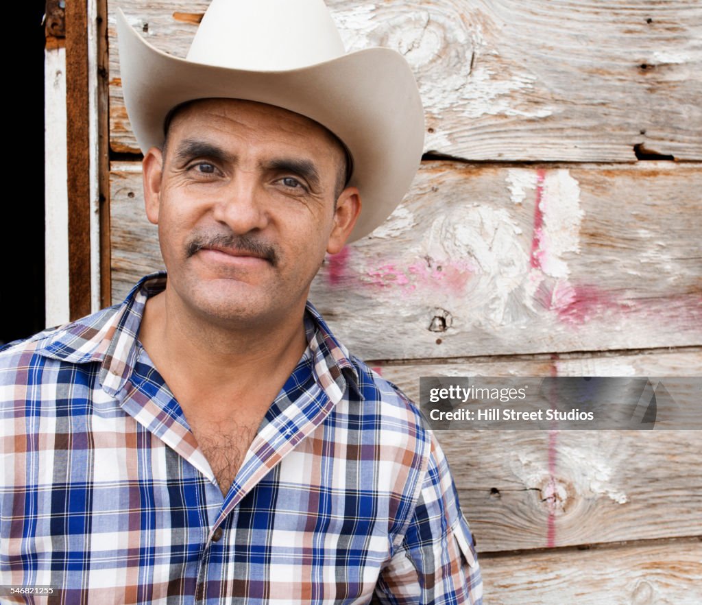 Hispanic man wearing cowboy hat