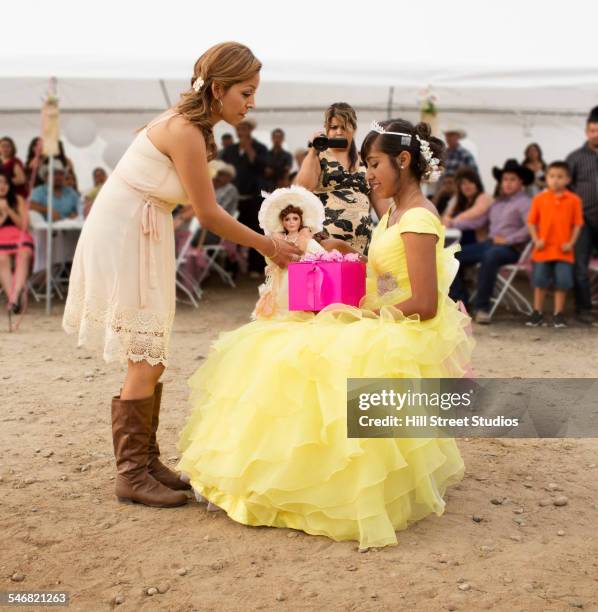 hispanic community giving gifts at quinceanera - quinceañera fotografías e imágenes de stock