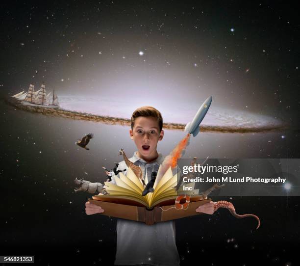 surprised boy watching colorful characters fly out of open book - spelling stock photos et images de collection