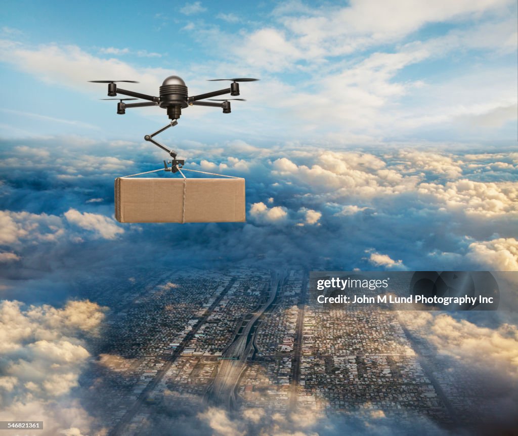 Drone delivering package over cityscape
