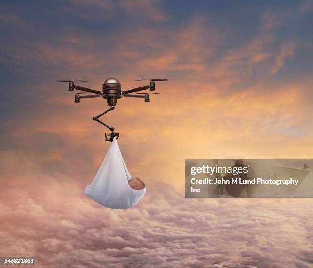 Babies Riding Drones Drone Delivering Newborn Baby In Sunrise Sky High-Res Stock Photo ...