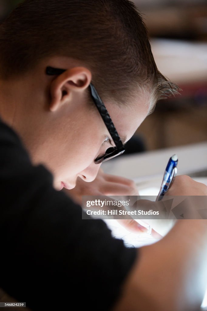 Close up of student tracing on light box