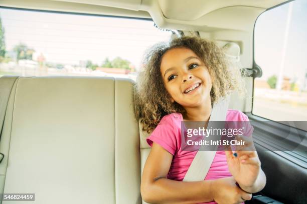 mixed race girl smiling in back seat of car - backseat bildbanksfoton och bilder
