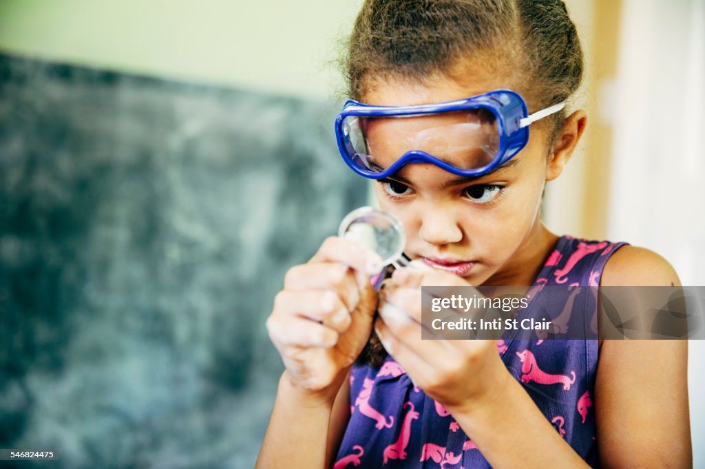 Mixed race girl doing science experiment at home