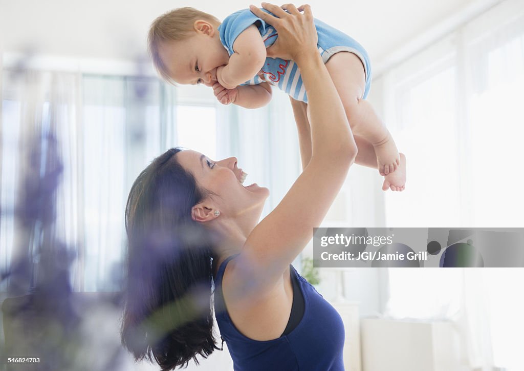 Close up of mixed race mother playing with baby