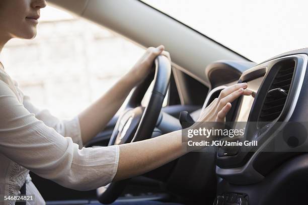caucasian woman using gps system in car - interattività foto e immagini stock