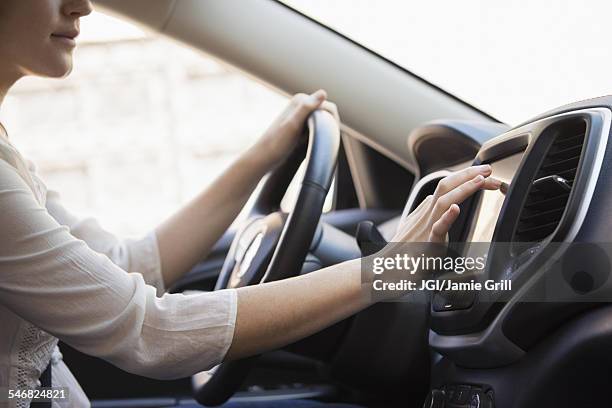 caucasian woman using gps system in car - auto radio stock pictures, royalty-free photos & images