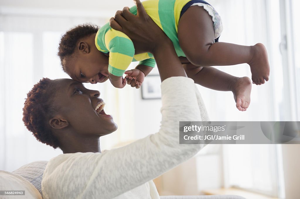 Black mother playing with baby boy