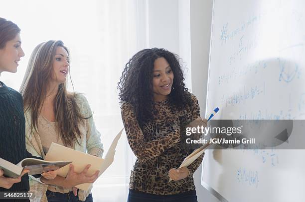 students using whiteboard in classroom - presentation folder stock pictures, royalty-free photos & images