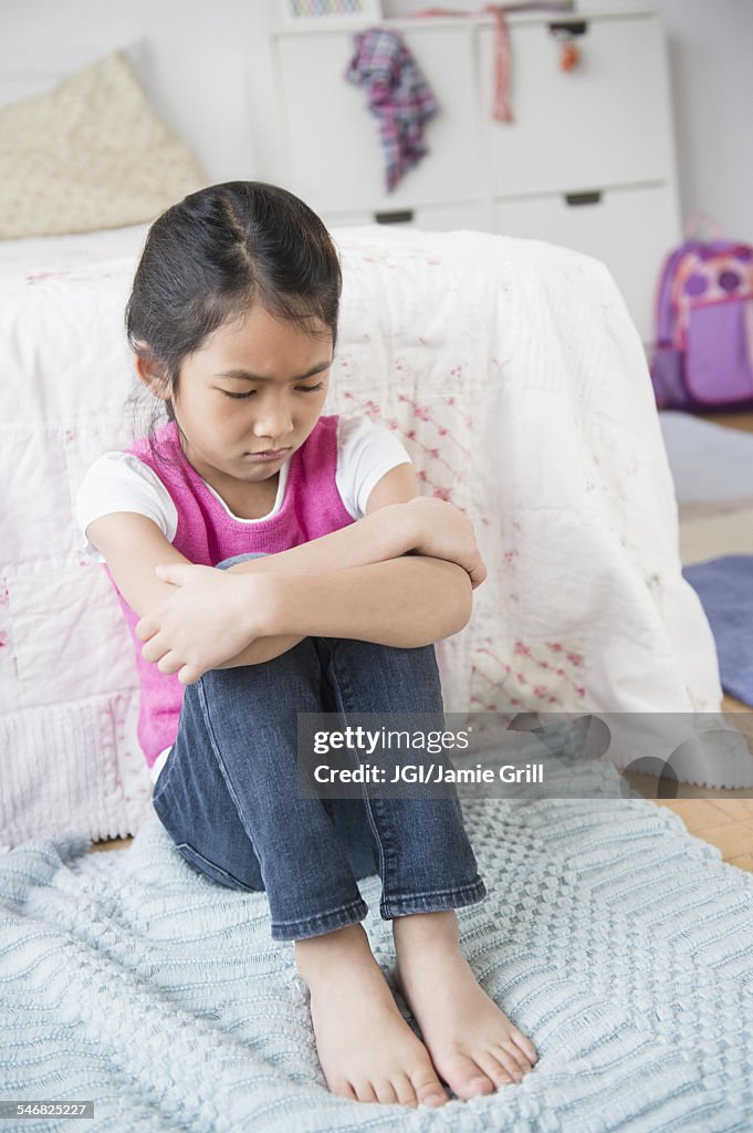 Vietnamese girl pouting in bedroom