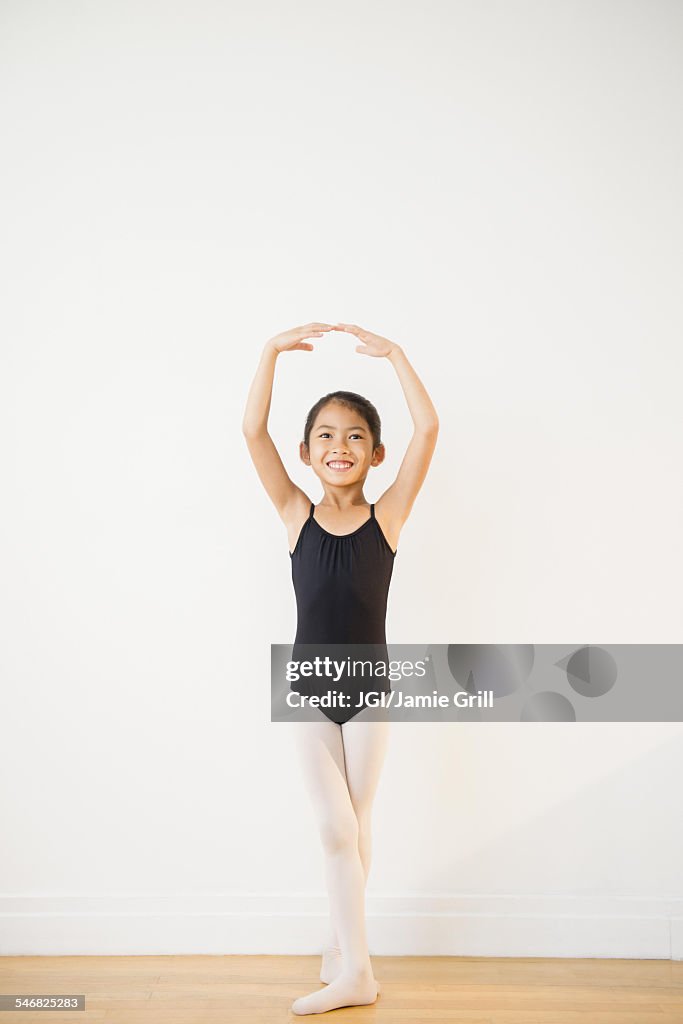 Vietnamese girl posing during ballet lesson