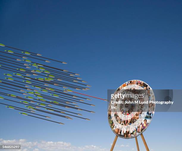 arrows shooting towards target with faces in blue sky - arrows target stock pictures, royalty-free photos & images