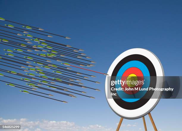 arrows shooting towards target in blue sky - arrows target fotografías e imágenes de stock