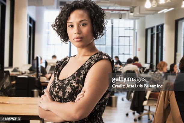 mixed race businesswoman standing in office - educational establishment stock pictures, royalty-free photos & images