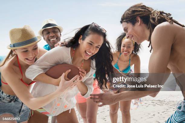 friends playing american football on beach - beach american football bildbanksfoton och bilder