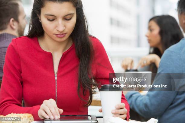 businesswoman using digital tablet at breakfast - 2000 teleworking stock pictures, royalty-free photos & images