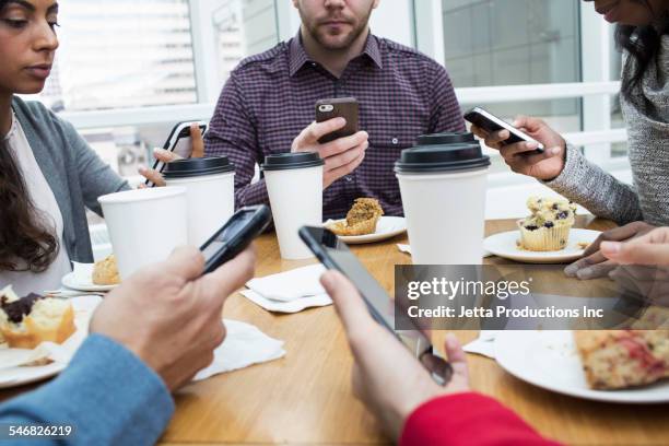 business people using cell phones at working breakfast - 2000 teleworking stock pictures, royalty-free photos & images