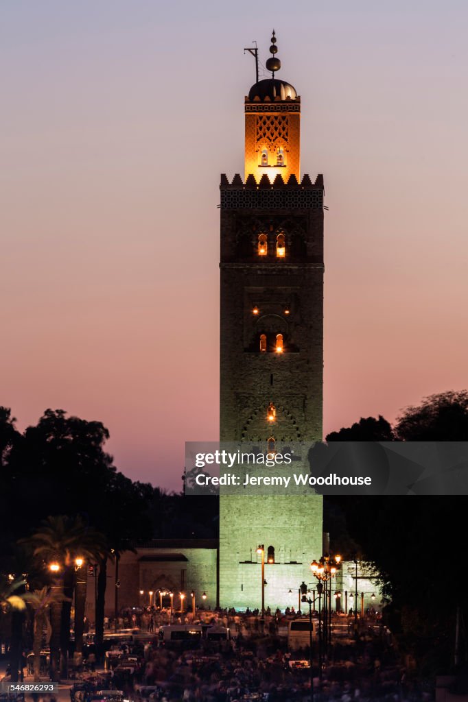 Illuminated Koutoubia mosque tower under sunset sky, Marrakech, Morocco