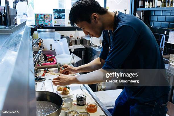 Chef prepares geoduck sashimi at the Taylor Shellfish Farms restaurant in the Sai Ying Pun area of Hong Kong, China, on Friday, June 17, 2016....