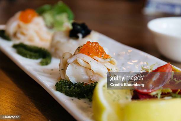 Plate of geoduck sashimi is arranged for a photograph at the Taylor Shellfish Farms restaurant in the Sai Ying Pun area of Hong Kong, China, on...