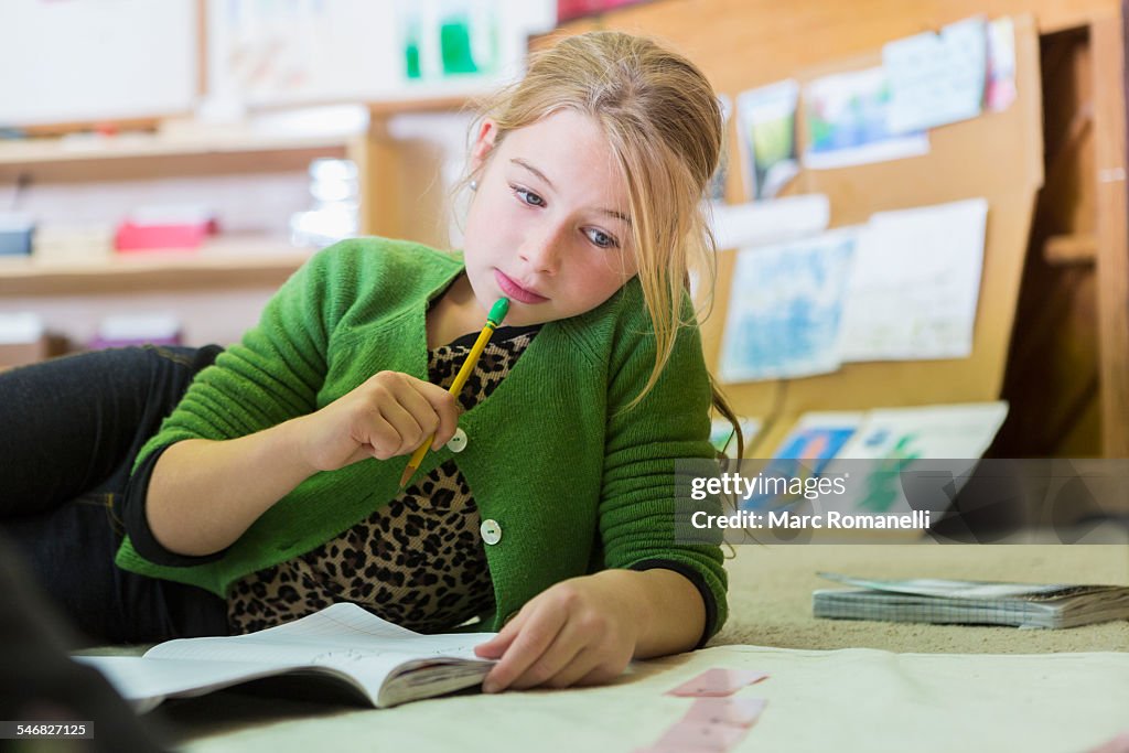 Caucasian girl working in classroom