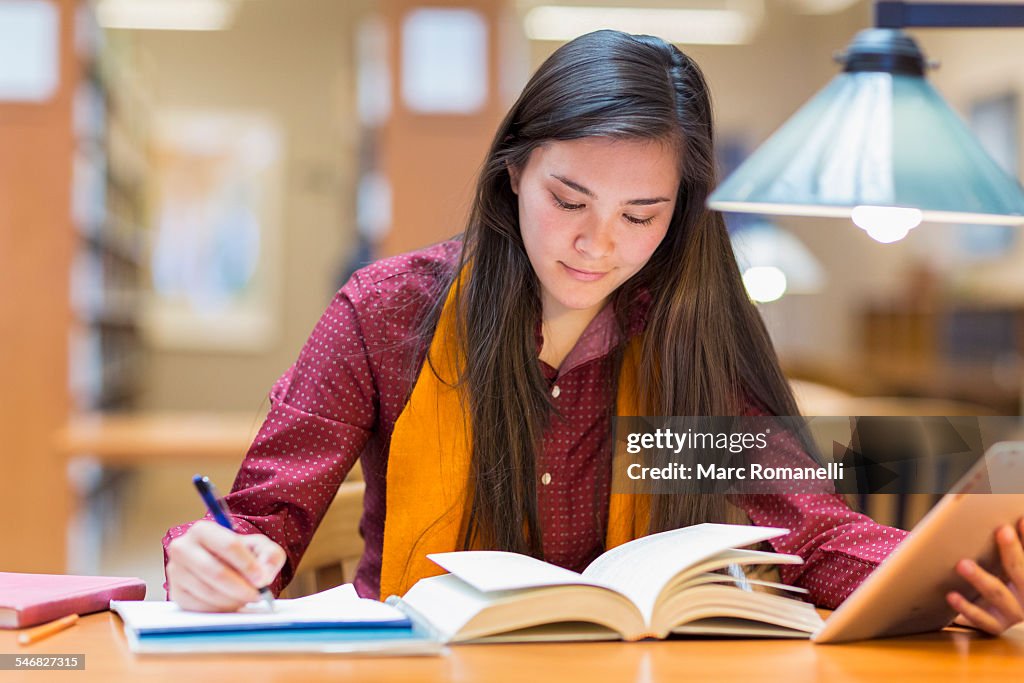 Mixed race student studying in library