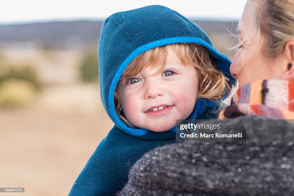 Caucasian mother carrying baby boy