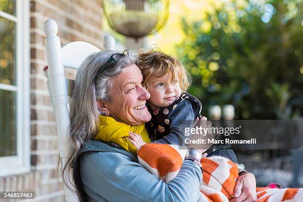 caucasian grandmother and grandson sitting on porch - cadeira de balanço - fotografias e filmes do acervo