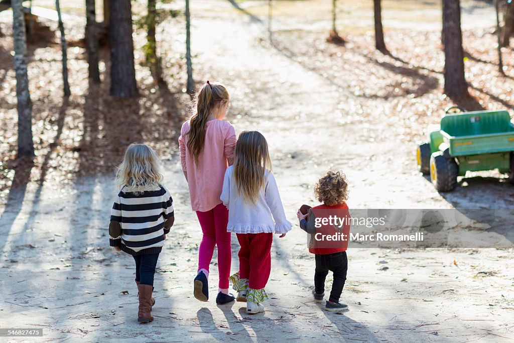 Caucasian children walking in yard