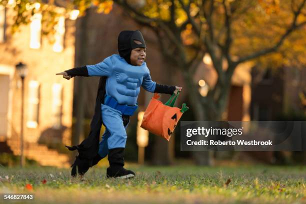 african american boy trick-or-treating on halloween - trick or treat stock pictures, royalty-free photos & images