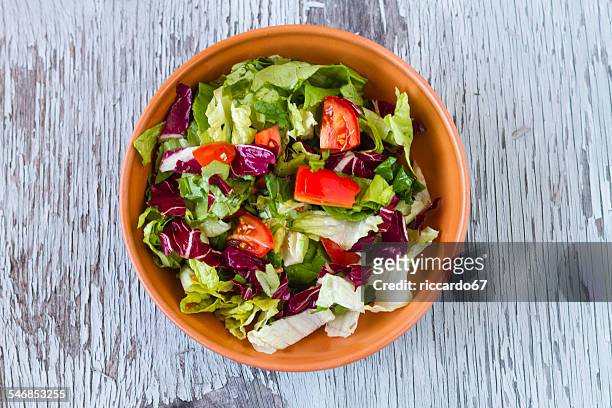 directly above shot of vegetable salad in bowl on wooden table - salad bowl stock pictures, royalty-free photos & images