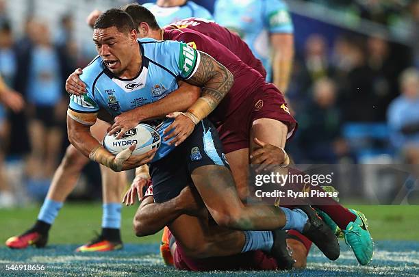 Tyson Frizell of the Blues is tackled during game three of the State Of Origin series between the New South Wales Blues and the Queensland Maroons at...