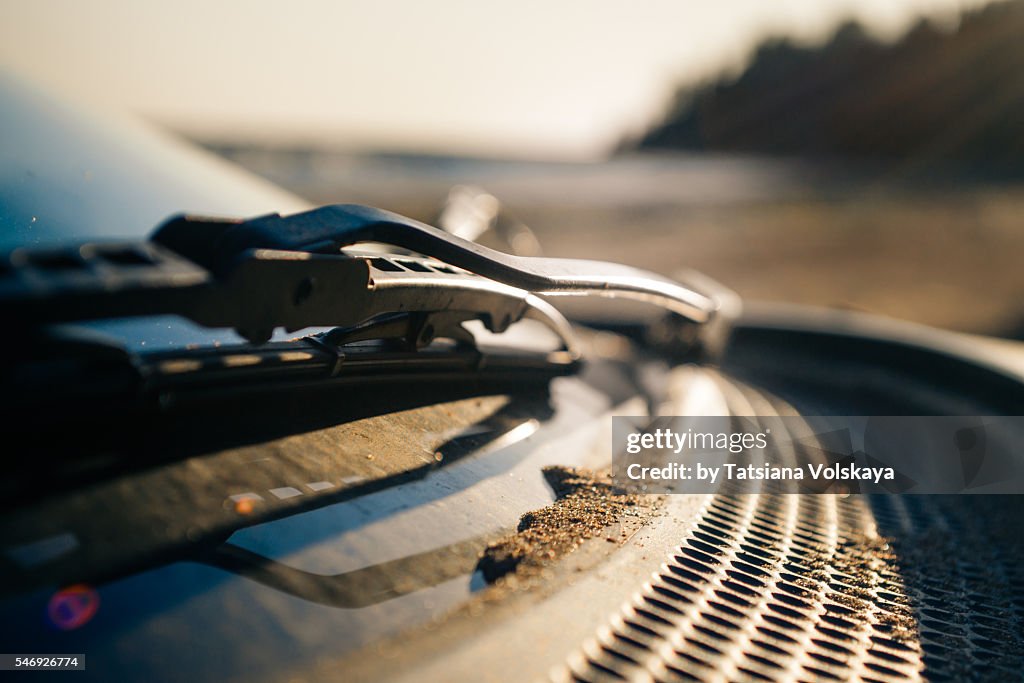 Car strewn by sand, close up view