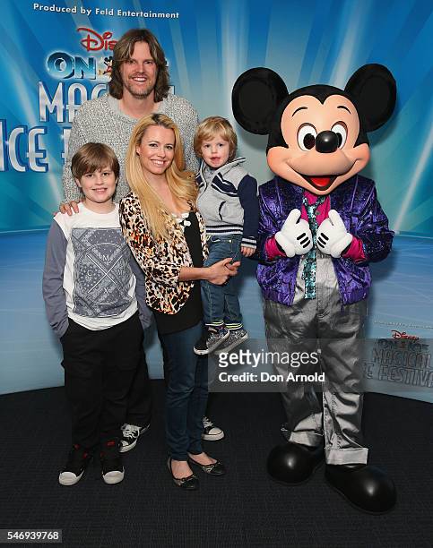 Nathan and Haley Bracken pose alongside their children ahead of the Disney On Ice premiere at Qudos Bank Arena on July 13, 2016 in Sydney, Australia.