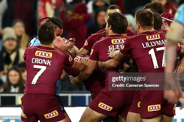 Andrew Fifita of the Blues tackles Gavin Cooper of the Maroons after Cooper scores a try during game three of the State Of Origin series between the...