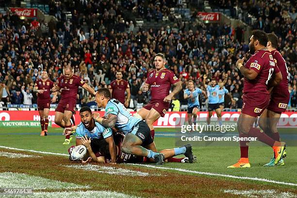 Michael Jennings of the Blues celebrates scoring the winning try during game three of the State Of Origin series between the New South Wales Blues...