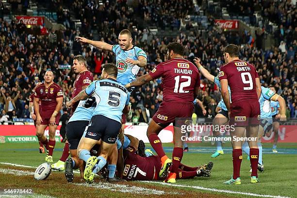 Michael Jennings of the Blues celebrates scoring the winning try during game three of the State Of Origin series between the New South Wales Blues...