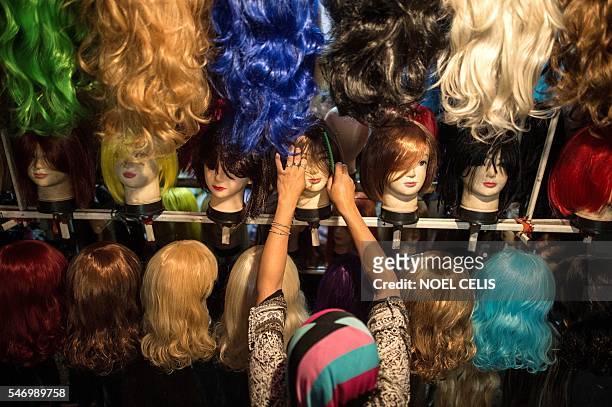 Vendor combs the wig of a mannequin at the Divisoria market in Manila on July 13, 2016. The Philippines' economy grew a better-than-expected 6.9...