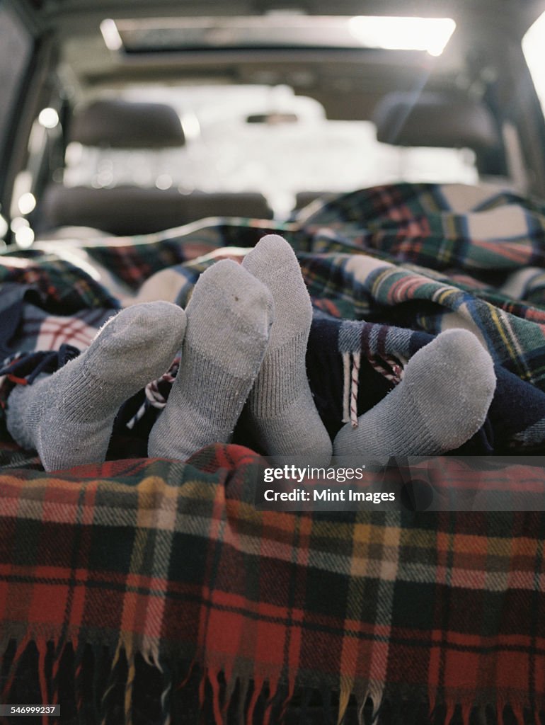 Couple sleeping in the back of their car.