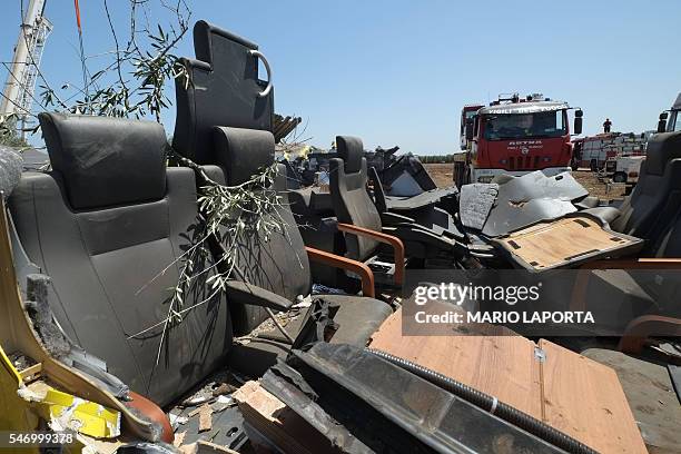 Remains of the train crash site lie on the ground on July 13, 2016 near Corato, in the southern Italian region of Puglia as rescuers searched for...