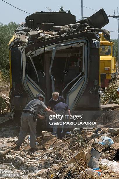 Members of the Italian Dental Division inspect the train crash site on July 13, 2016 near Corato, in the southern Italian region of Puglia as...