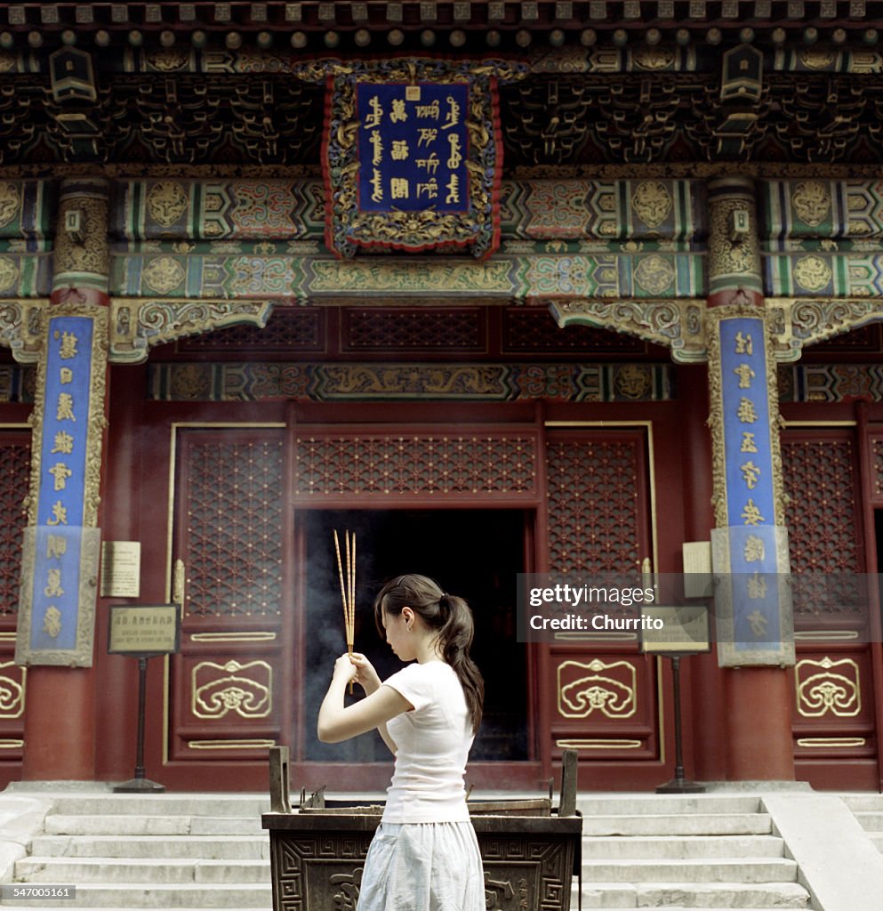 Woman praying at temple, Beijing, China