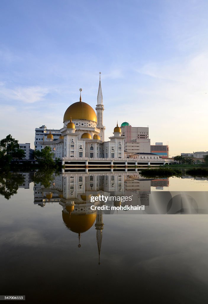 Malaysia, Klang, Holy Mosque, Symmetrical view of white mosque with golden dome reflecting in river