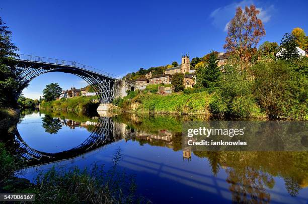 uk, england, shropshire, telford, symmetrical view of ironbridge and hill reflecting in water - telford foto e immagini stock