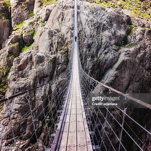 Person standing on Trift Bridge, Alps, Switzerland